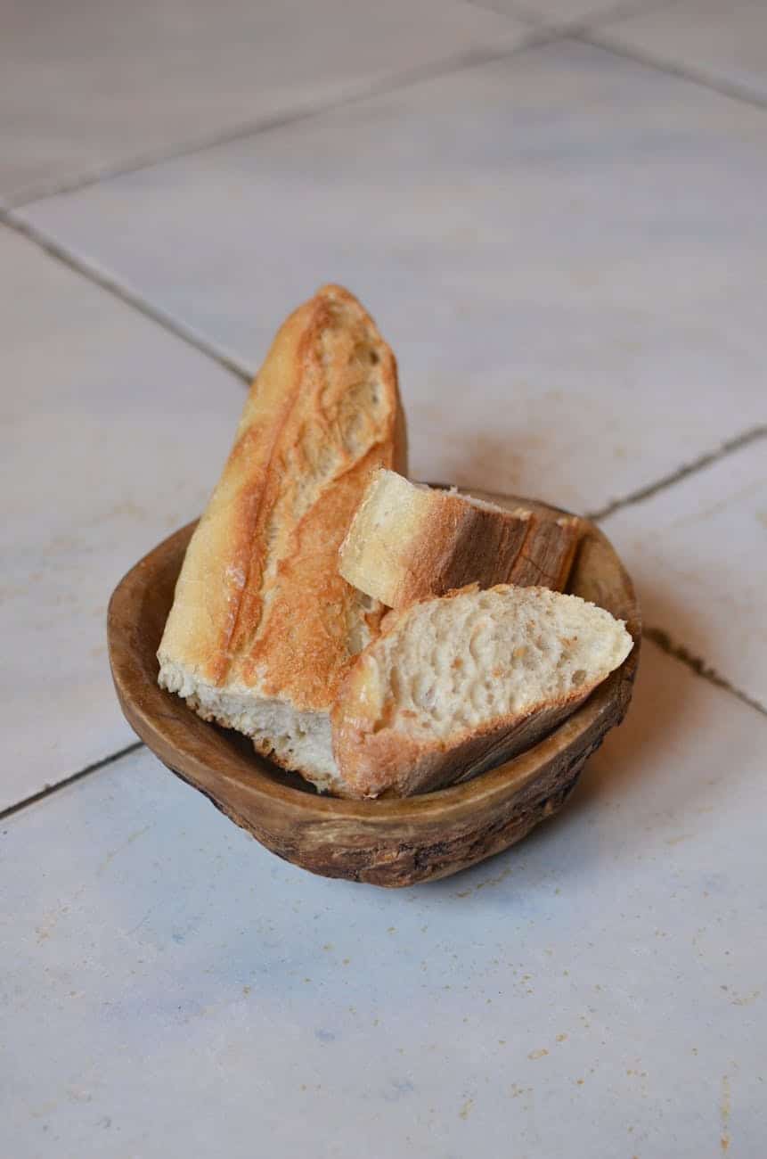 fresh cut bread in wooden bowl