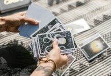 person holding white and black book