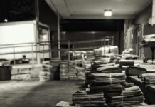 piles of bundled newspapers on a concrete floor