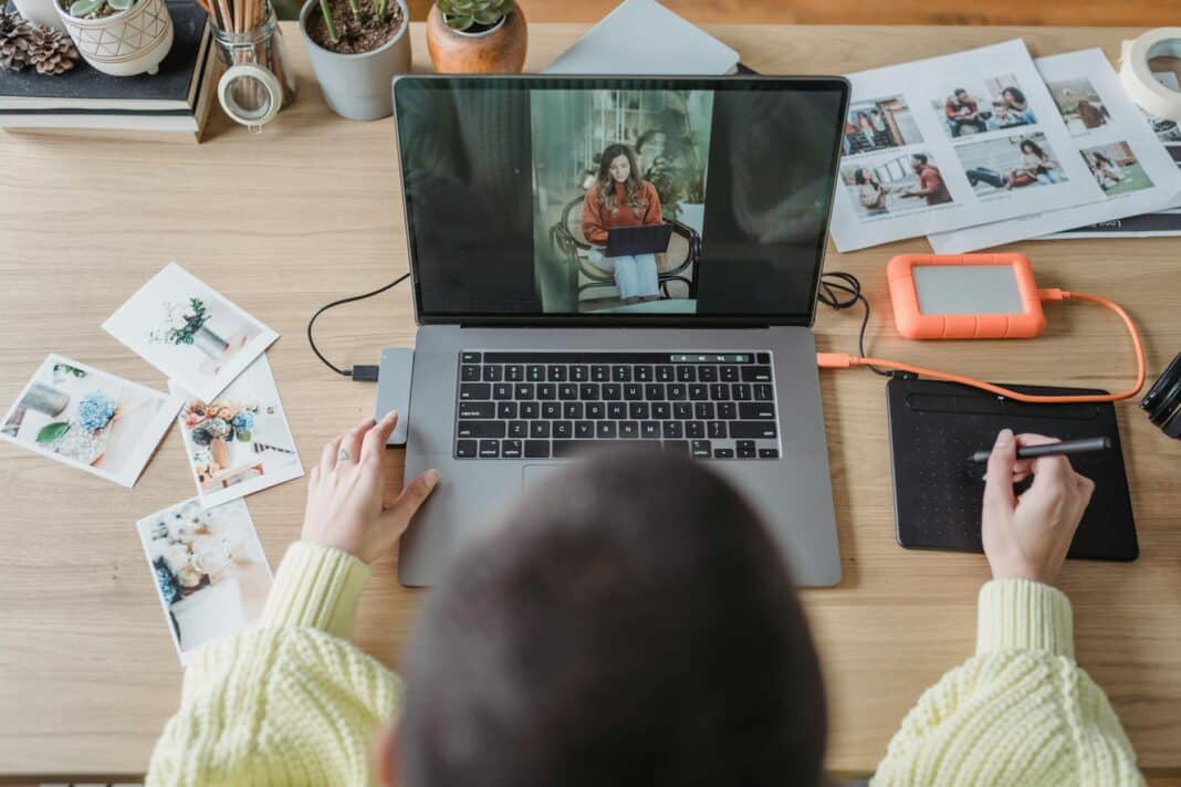 anonymous woman retouching photos on netbook