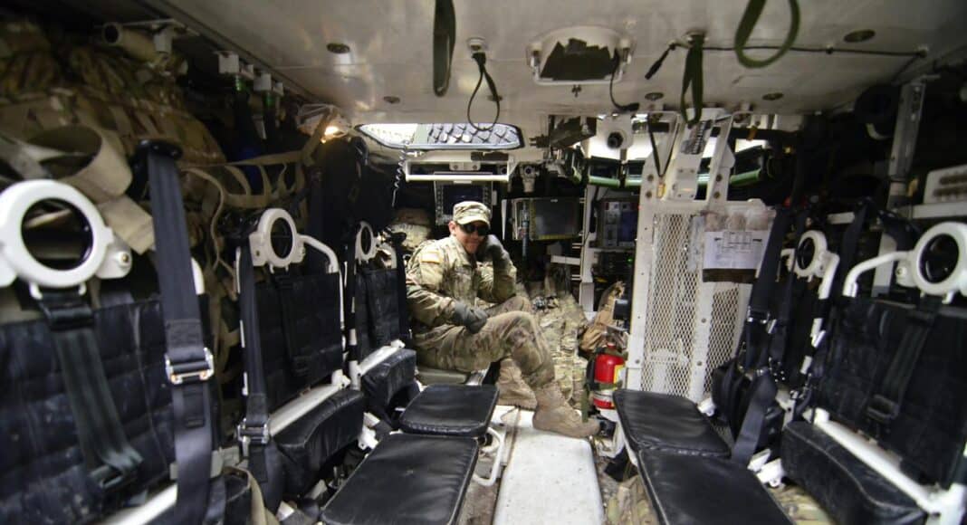 man in soldier suit sitting in black leather seat