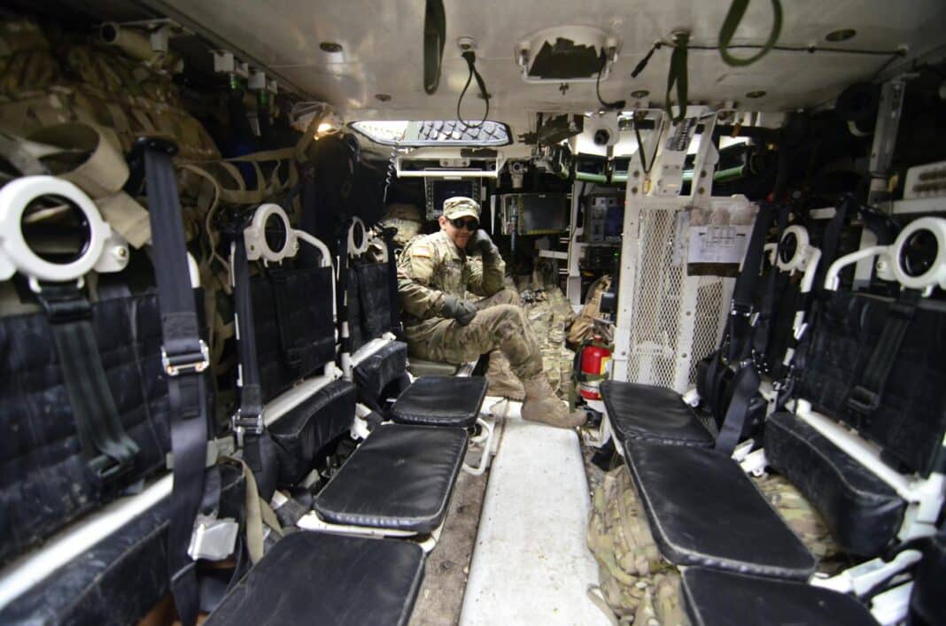 man in soldier suit sitting in black leather seat