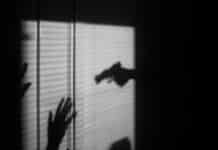 silhouette of person on window