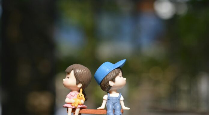 boy and girl sitting on bench toy