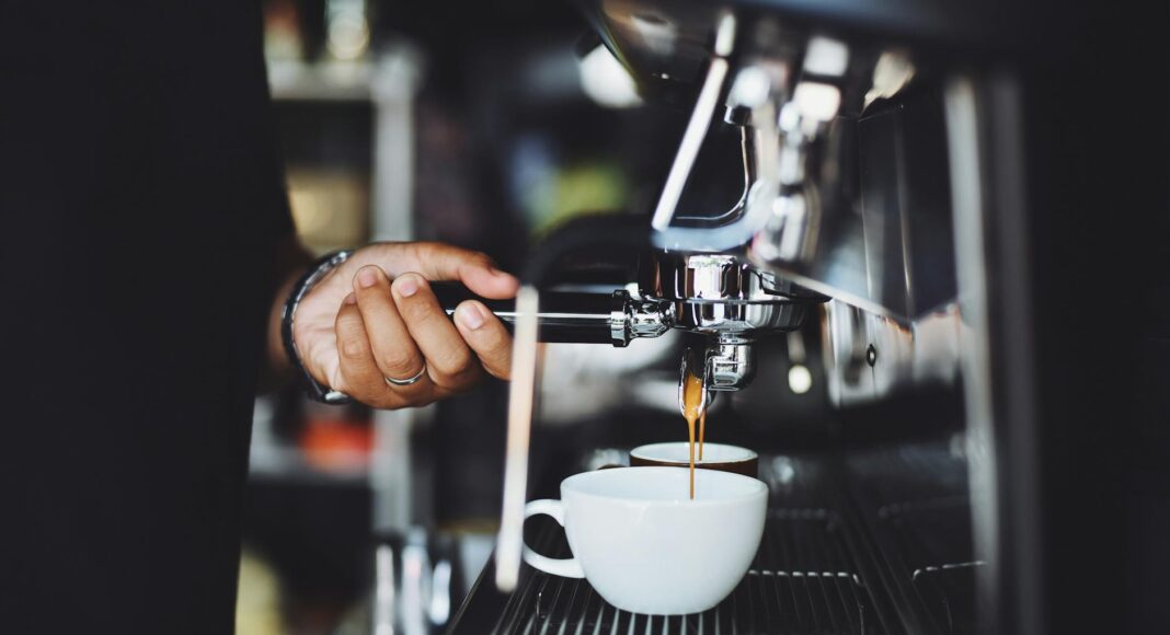 close up of hand holding coffee machine
