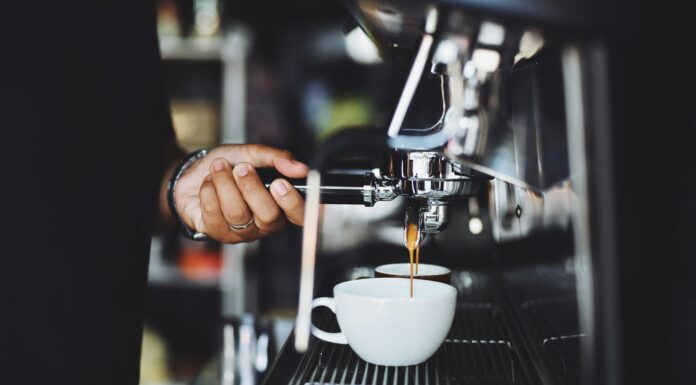 close up of hand holding coffee machine