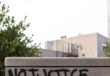 a cement wall with graffiti written on it