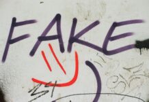graffiti on a wall that says fake