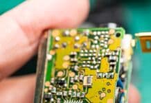 A close up of a person holding a small electronic device