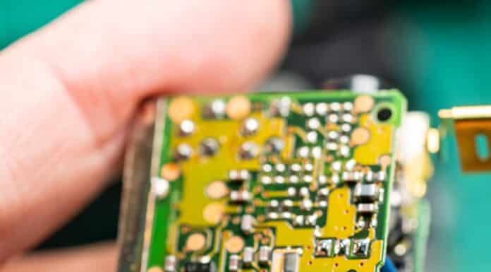 A close up of a person holding a small electronic device