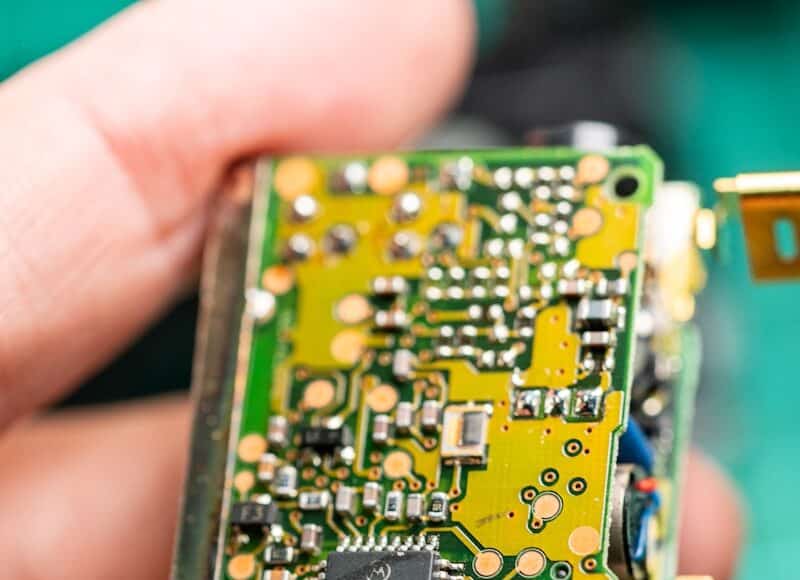 A close up of a person holding a small electronic device