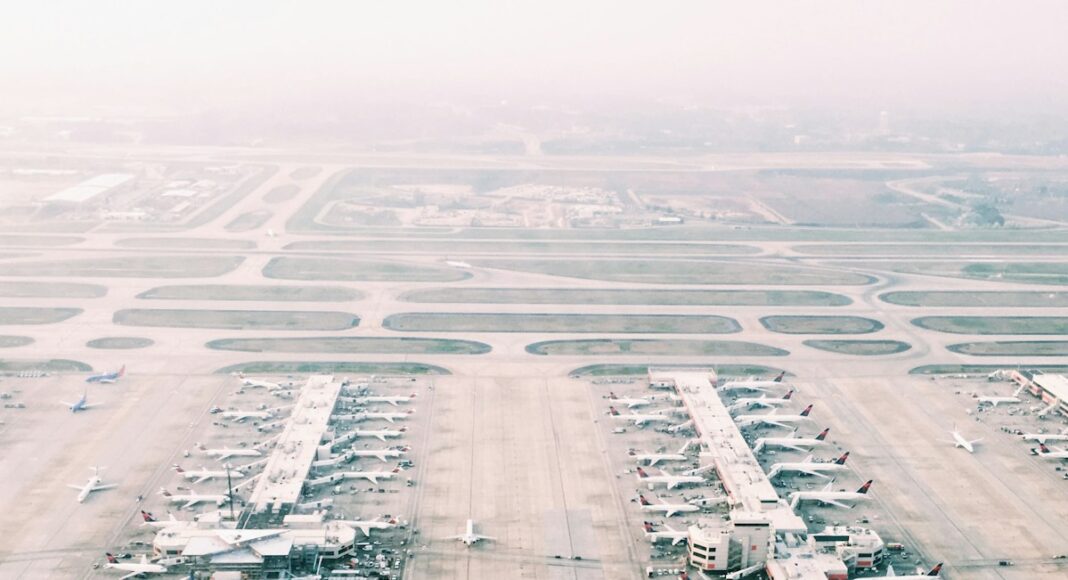 aerial view of airport with lots of airplanes during daytime