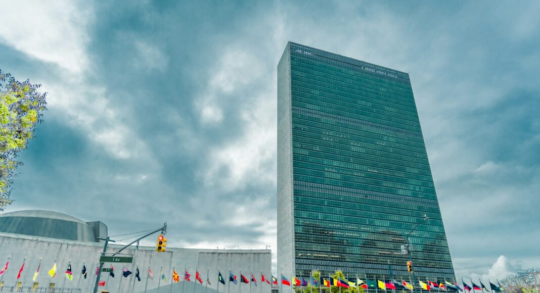 A very tall building sitting next to a body of water