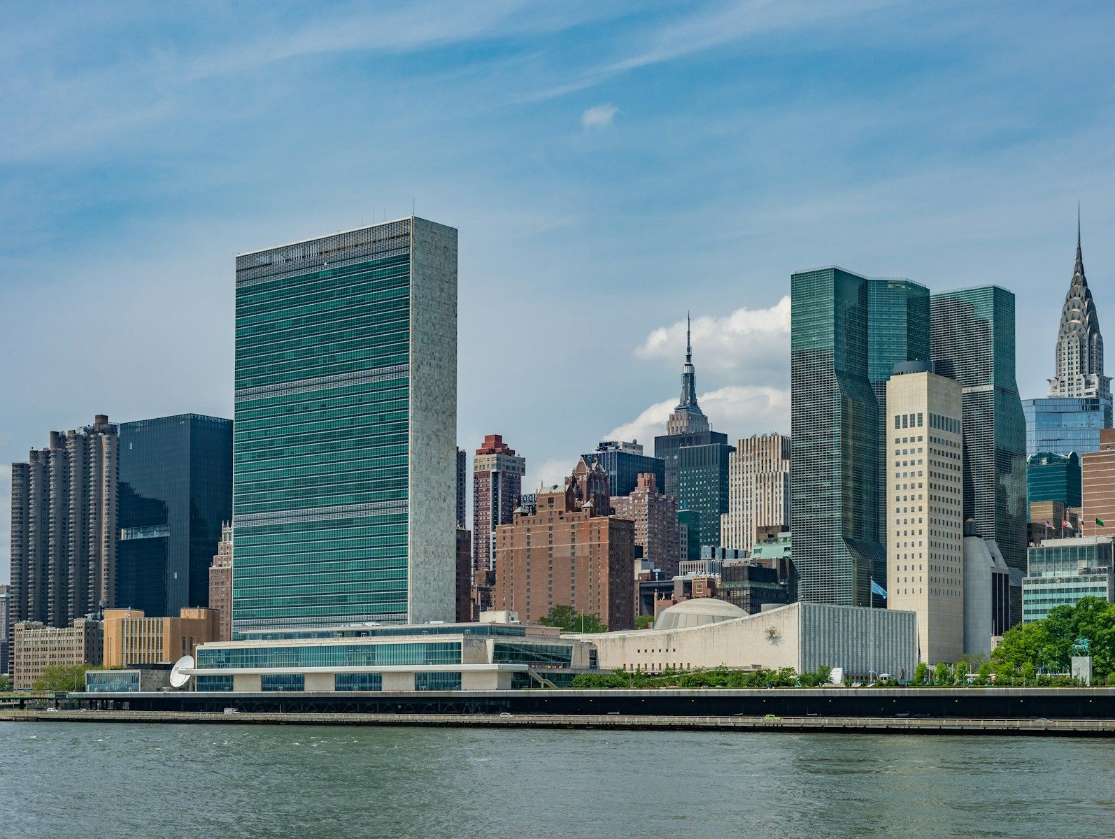 city buildings near body of water during daytime