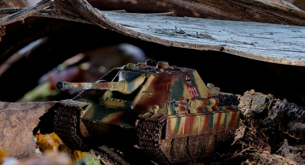 A toy tank is sitting on the ground