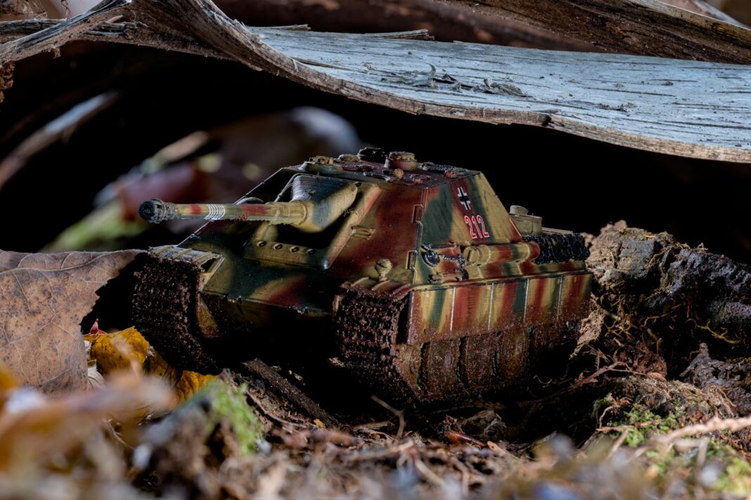 A toy tank is sitting on the ground