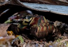 A toy tank is sitting on the ground