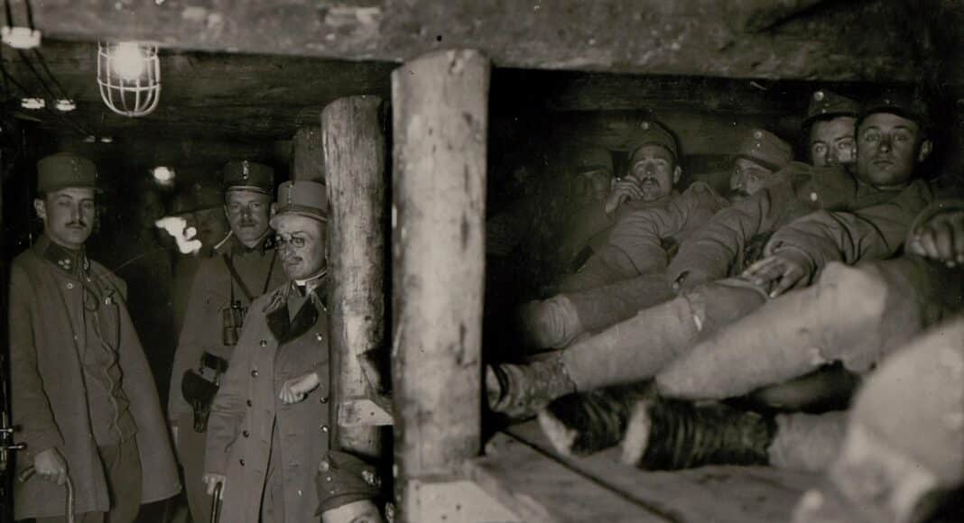 grayscale photography of soldier men inside cave
