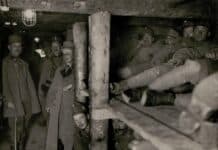 grayscale photography of soldier men inside cave