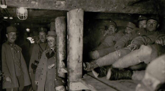 grayscale photography of soldier men inside cave