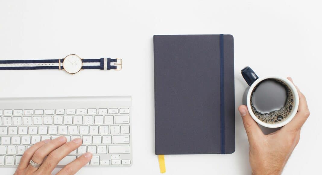person holding black mug filled with black liquid