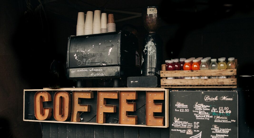 brown coffee signage beside poster