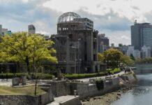 gray concrete building near body of water