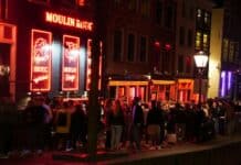people walking on street during night time