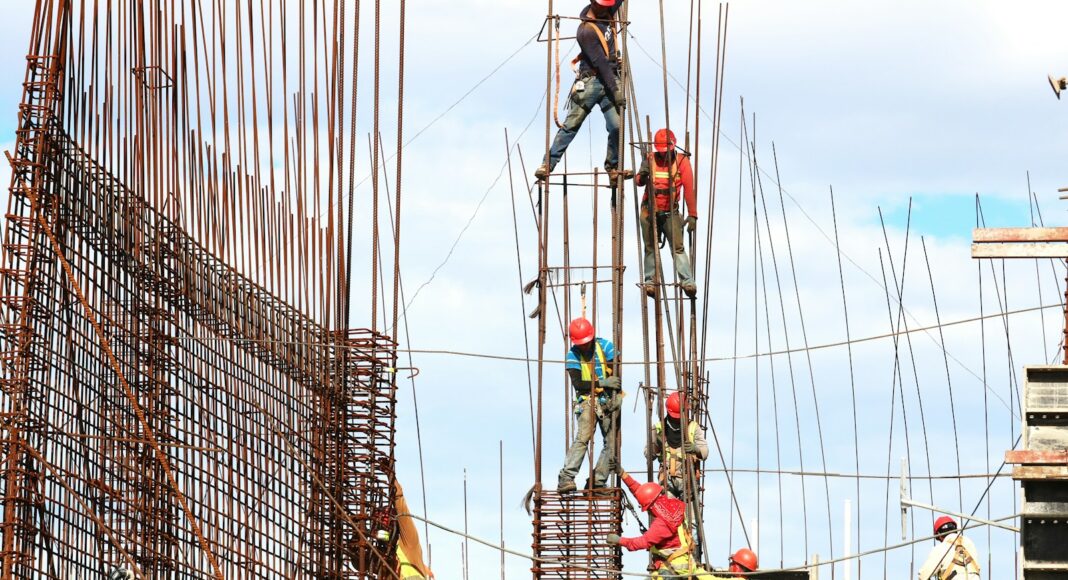 people working on building during daytime