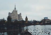 photography of cathedral near lake during daytime