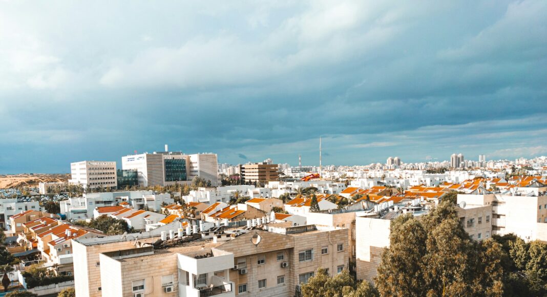 white concrete building near green trees during daytime