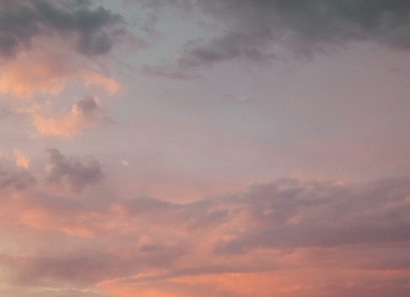 a couple of people standing on top of a rocky beach