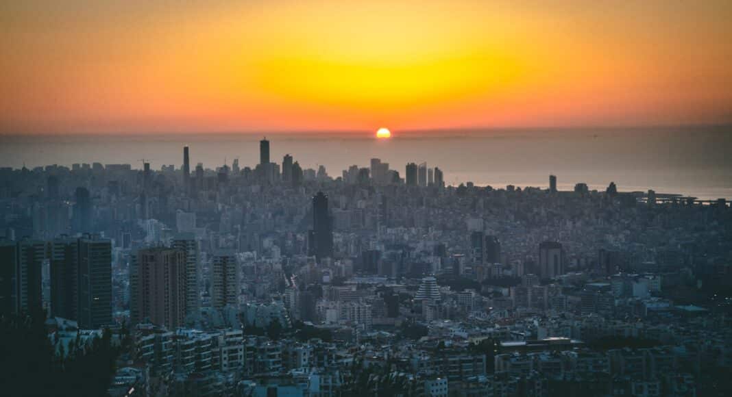 city skyline during sunset with orange sky