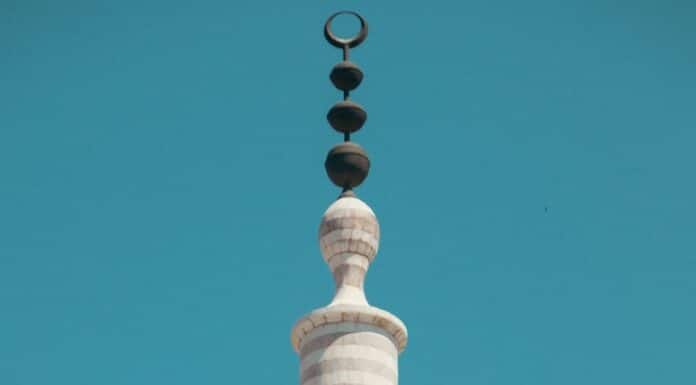 a tall tower with a clock on the top of it