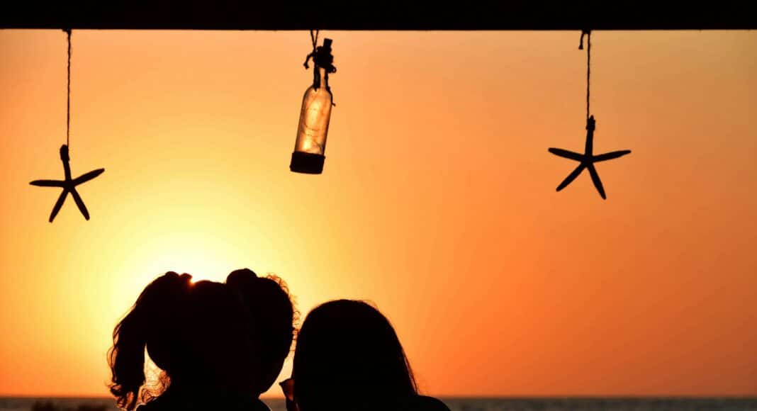 a couple of people sitting next to each other