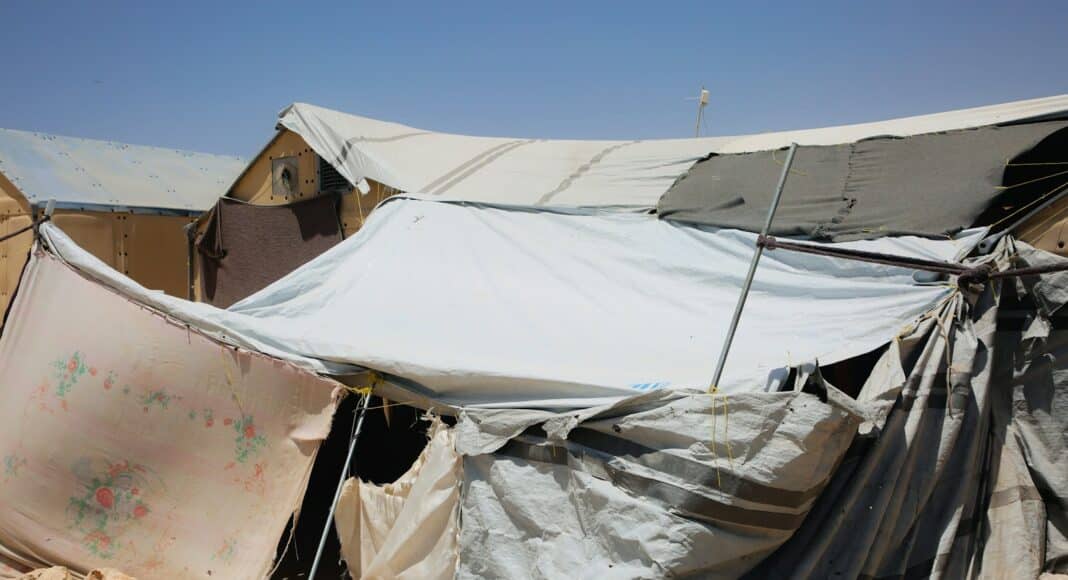 A group of tents sitting on top of a dirt field