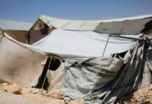 A group of tents sitting on top of a dirt field