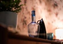 clear glass bottle on brown wooden table