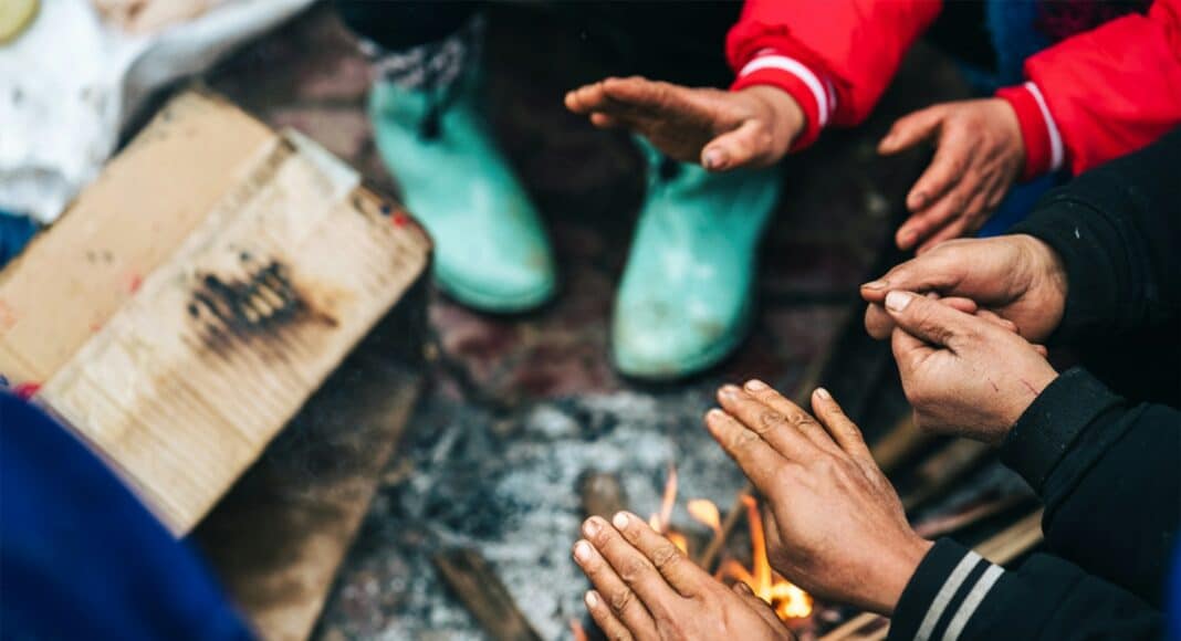 A group of people sitting around a fire