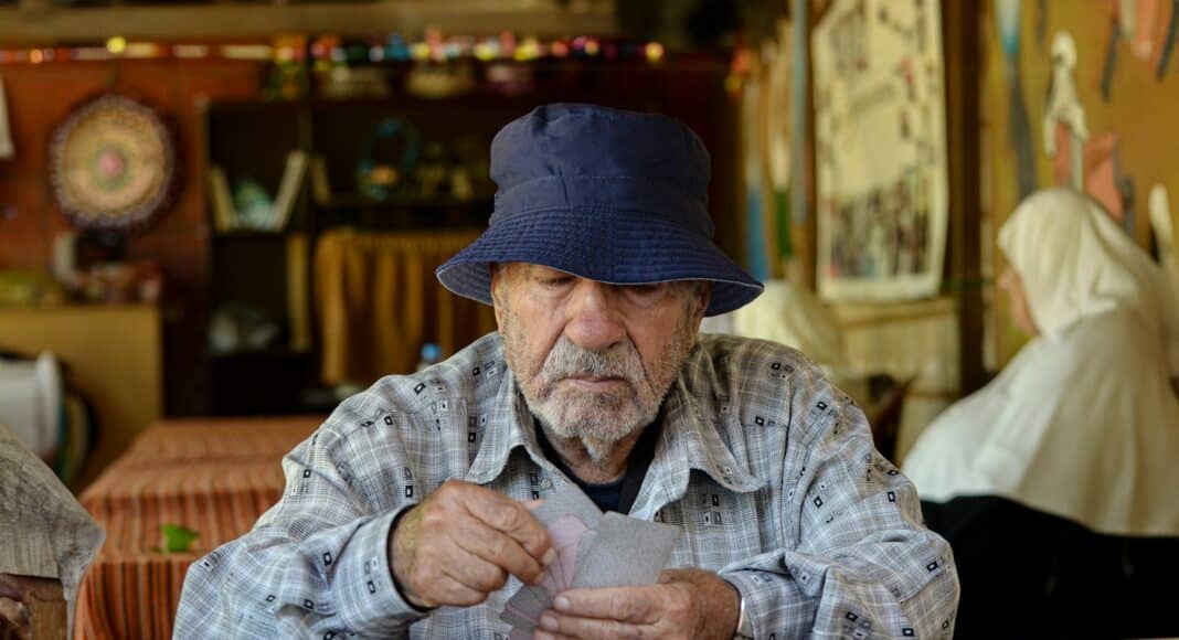 A man sitting at a table with a hat on