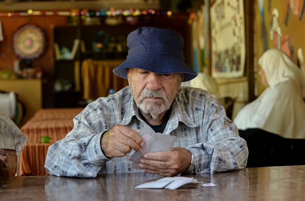 A man sitting at a table with a hat on