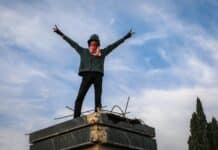 A person standing on top of a building