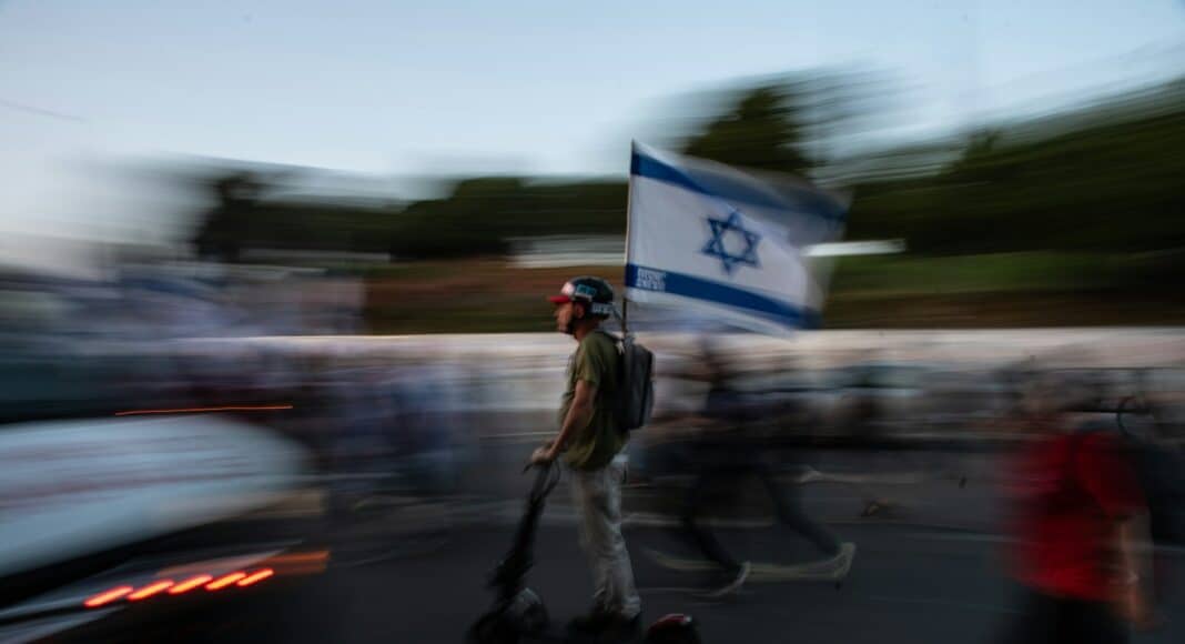 A blurry photo of a man riding a scooter