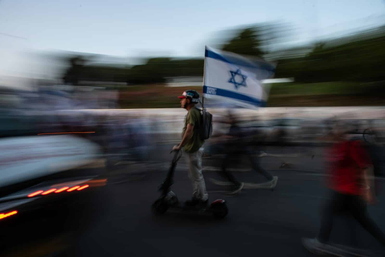 A blurry photo of a man riding a scooter