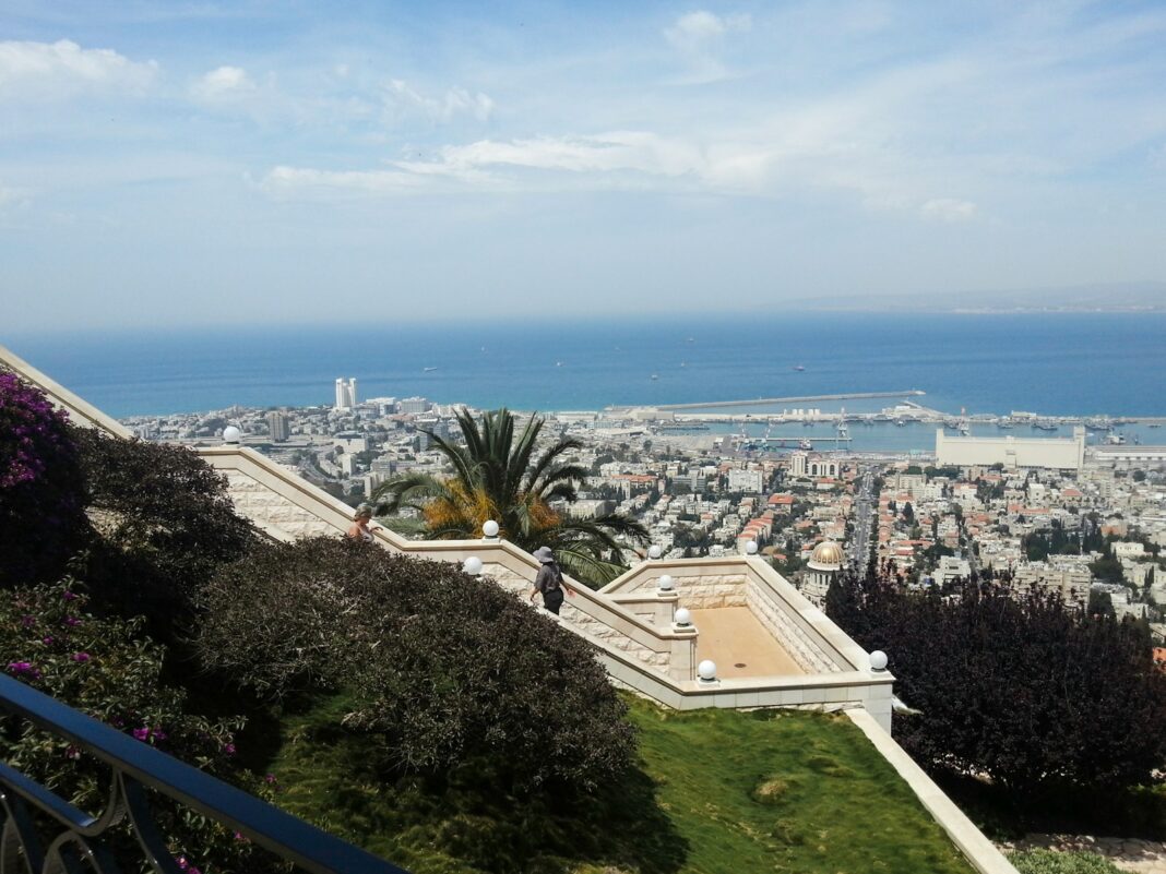 aerial view of city buildings near body of water during daytime