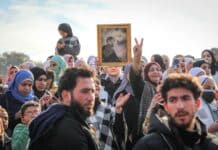 A crowd of people standing around each other