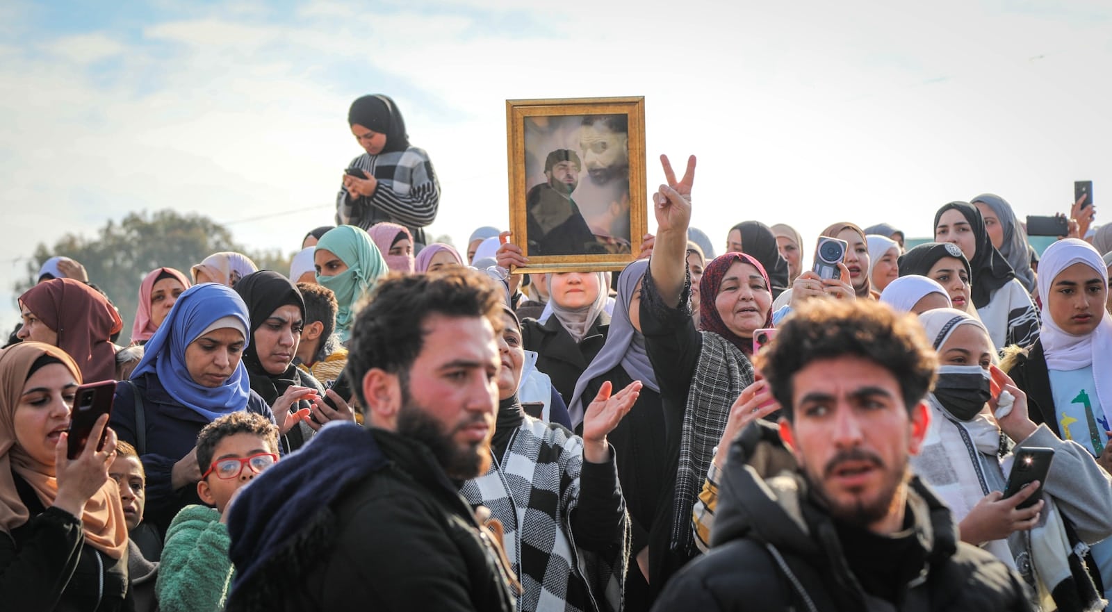 A crowd of people standing around each other