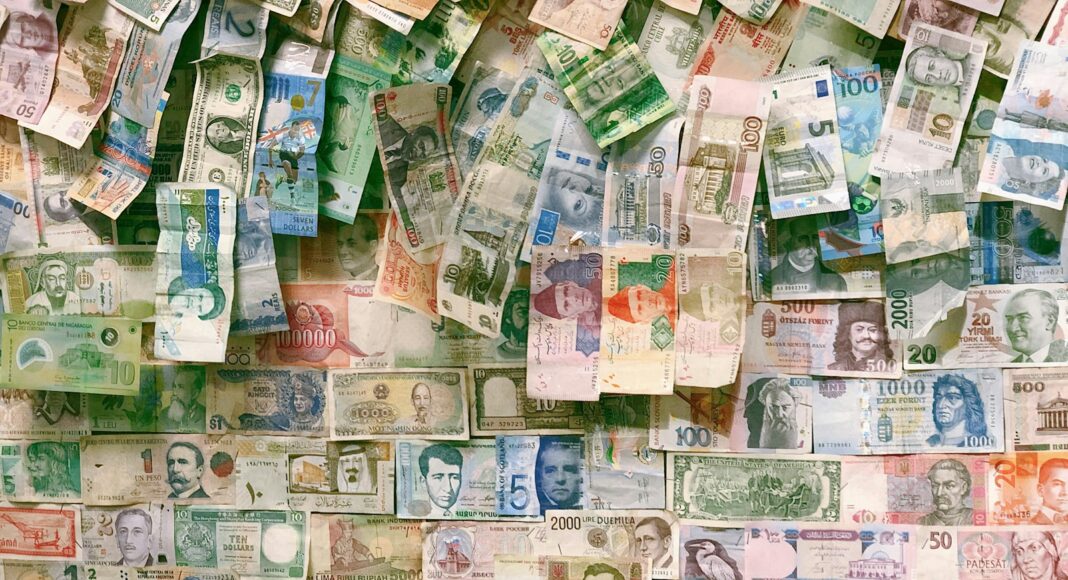 10 and 10 banknotes on brown wooden table