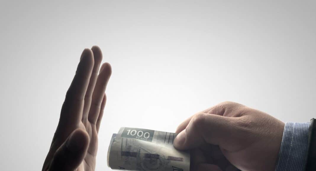 a person holding a stack of cash