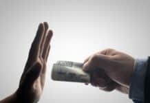 a person holding a stack of cash